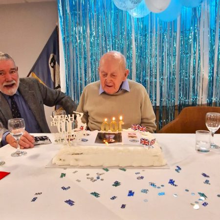 Peter Belcher blowing out candles on his Birthday Cake